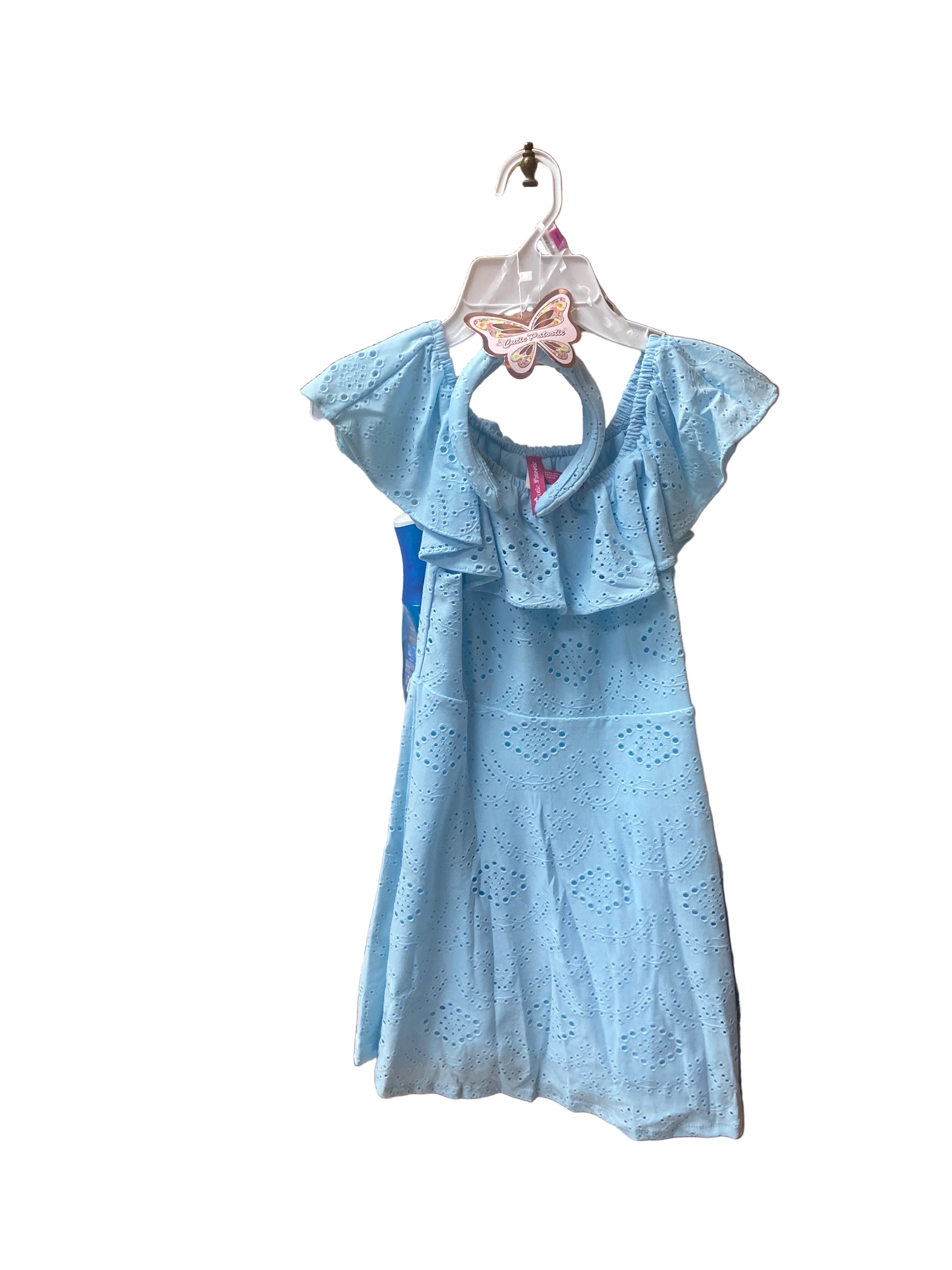 The Eyelet Dress is a light blue, off-the-shoulder dress with ruffled sleeves and eyelet details, displayed on a white hanger adorned with a pink butterfly clip against a plain white background.